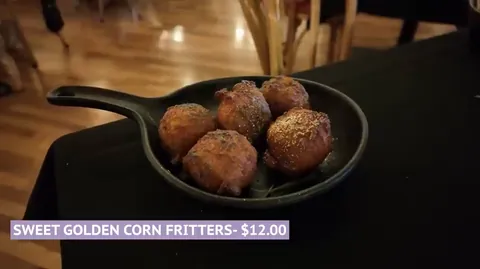 Sweet golden corn fritters with red chili honey at The Diamond Horseshoe